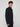 A young man with curly brown hair wears a dark blue PROJEK RAW MEN’S 1/4 ZIP MOCK NECK PULLOVER SWEATER with side pockets, standing against a plain light gray background and facing slightly to the side.