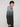 A young man with curly brown hair models the PROJEK RAW MENS KNIT HOODED SWEATER BONDED WITH POLAR FLEECE, featuring a gray and black gradient. He stands sideways, facing the camera against a plain light background.