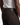 A person wearing dark brown SOLID BUNGEE 5-POCKET PANTS by PROJEK RAW and a white ribbed tank top, shown from the back. The classic-fit pants feature a black leather patch with PROJEK RAW embossed above the right back pocket.