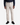 A person stands facing forward against a plain white background, wearing PROJEK RAW’s SOLID BUNGEE CARGO PANT for men in light beige with utility pockets, paired with a dark long-sleeve shirt and black sneakers.