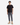 A person stands facing forward against a plain white background, wearing a black T-shirt, tan lace-up boots, and PROJEK RAW SOLID BUNGEE PULL ON JOGGER pants in gray with a relaxed fit and stretch fabrication.