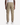 A person is shown from the back, standing against a plain white background, wearing PROJEK RAW’s SOLID BUNGEE CARGO CLASSIC FIT JOGGER pants in tan with cargo pockets and paired with white sneakers.