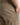 Close-up of a person wearing the PROJEK RAW SOLID BUNGEE RELAXED FIT CARGO PANT in khaki stretch fabric, with one hand in the front pocket. These pants feature utility pockets, a side cargo pocket, and a back welt pocket.
