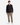 A young man stands facing forward against a plain white background, wearing a black button-up shirt, PROJEK RAW SOLID BUNGEE RELAXED FIT CARGO PANT in tan with utility pockets, and white sneakers.
