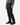 A person wearing a gray sweater and the PROJEK RAW SOLID BUNGEE LOOSE FIT CARGO PANT for men, featuring multiple utility pockets, paired with a black belt and black lace-up boots, stands against a plain white background—perfectly capturing modern urban wear style.