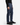 A person wearing the PROJEK RAW SOLID BUNGEE LOOSE FIT CARGO PANT for men in navy blue, featuring utility pockets, paired with a black long-sleeve sweater, black sneakers, and light gray socks, stands against a plain white background.