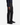 A person is seen from the waist down wearing PROJEK RAW SOLID BUNGEE 5-POCKET RELAXED FIT PANTS, paired with a dark long-sleeve shirt and black sneakers, standing against a plain white background.
