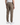 A person is shown from the back against a plain, light background, wearing PROJEK RAW’s SOLID BUNGEE CARGO RELAXED FIT PULL ON JOGGER pants in khaki. These joggers feature a relaxed fit, stretch fabrication, back pockets with flaps, elastic cuffs, and are paired with white sneakers.