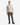 A man wearing a light beige sweater, PROJEK RAW TEXTURED BUNGEE CLASSIC FIT CHINO PANT in olive green, and black sneakers stands facing forward against a plain white background.