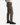 A person wearing PROJEK RAW TEXTURED BUNGEE CLASSIC FIT CHINO PANT in taupe, a beige sweater, and black sneakers is shown standing sideways against a white background.