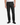 A person wearing PROJEK RAW CAVALRY TWILL BUNGEE CHINO PANTS, a white shirt, and black shoes stands against a plain white background.