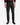 A man stands against a plain white background with arms relaxed at his sides, wearing PROJEK RAW CAVALRY TWILL BUNGEE 5-POCKET PANTS in a classic fit, paired with black dress shoes and a dark red long-sleeve sweater. These versatile pants by PROJEK RAW combine timeless style with modern sophistication.