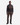 A man stands facing forward against a plain white background, wearing a gray and brown striped half-zip sweater, PROJEK RAW CAVALRY TWILL BUNGEE 5-POCKET PANTS in a rich brown hue, and black shoes.