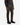 A person wearing PROJEK RAW CAVALRY TWILL BUNGEE 5-POCKET PANTS in brown, a dark gray ribbed sweater with colored stripes, and black sneakers, standing against a plain white background.