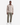 A man stands facing forward against a plain white background, wearing olive green PROJEK RAW SPONGEE BUNGEE LOOSE FIT CHINO PANTS, a beige button-up shirt with front pockets, and white sneakers.