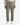 A person wearing the PROJEK RAW SPONGEE BUNGEE LOOSE FIT CHINO PANT in a utility-inspired light olive green shade, paired with a beige long-sleeve shirt and white sneakers, standing against a white background. The photo is cropped from the chest down.