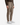 A person is wearing the PROJEK RAW MEN’S SOLID BUNGEE RELAXED FIT CARGO JOGGER, featuring utility-inspired details, elastic cuffs, and a drawstring waist. The joggers are paired with a dark sweater and white sneakers, with the individual standing against a plain white background.