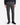 A man is wearing PROJEK RAW PLAID BUNGEE CLASSIC FIT CHINO PANTS in gray plaid, paired with a dark long-sleeve shirt and black dress shoes, standing against a white background.