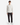 A young man stands facing forward against a plain white background, wearing a long-sleeve white shirt, PROJEK RAW PLAID BUNGEE RELAXED FIT CHINO PANTS that feature modern tailoring, and white sneakers.