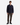 A person stands facing forward against a plain white background, wearing a dark plaid button-up shirt, black sneakers, and the PROJEK RAW CANVAS BUNGEE CLASSIC FIT PULL ON JOGGER—olive canvas cargo jogger pants featuring a tapered leg and adjustable drawcord.