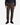 A person stands against a plain white background wearing the PROJEK RAW CANVAS BUNGEE CLASSIC FIT PULL ON JOGGER in olive, featuring an adjustable drawcord and tapered leg, paired with a dark plaid shirt and black sneakers.