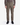 A person wearing PROJEK RAW CANVAS BUNGEE RELAXED FIT CARGO PANTS in olive green, a brown shirt, and black sneakers stands facing forward against a plain white background.