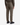 A person seen from the back, against a white background, wears PROJEK RAW’s CANVAS BUNGEE RELAXED FIT CARGO PANTS in olive green—crafted from structured canvas with flap pockets and a relaxed fit for a modern workwear-inspired look—paired with black sneakers.