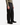 A person is shown from the lower torso down, wearing PROJEK RAW’s CANVAS BUNGEE LOOSE FIT CHINO PANTS in black, paired with a green button-up shirt and black dress shoes, standing against a plain white background.