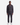 A man stands facing forward against a plain white background, wearing PROJEK RAW PRATOFLEX CLASSIC FIT 5-POCKET PANTS paired with a charcoal quarter-zip sweater and white sneakers for everyday versatility.