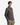 A young man stands with his hands in his pockets, looking at the camera against a plain white background, wearing PROJEK RAW’s MEN’S 24/7 BUTTON-UP MODERN FIT KNIT SHIRT in dark brown and khaki pants.