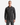 A man stands facing forward against a plain white background, wearing the PROJEK RAW RELAXED FIT DENIM SHIRT—a black denim button-up featuring a relaxed fit and two chest pockets.