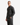 A man with short hair, dressed in the PROJEK RAW RELAXED FIT DENIM SHIRT in dark gray and matching gray pants, stands at a slight angle against a plain white background, demonstrating the shirt’s effortless everyday versatility.