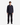 A man stands facing forward, wearing the PROJEK RAW KNIT FLANNEL SHIRT in a classic cut, paired with black pants and black shoes against a white background—a true wardrobe essential.