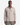 A man stands facing forward against a plain white background, wearing the PROJEK RAW JACQUARD KNIT OVERSHIRT in light beige with two front chest pockets, paired with olive green pants.
