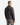 A person with short hair, dressed in a gray PROJEK RAW KNIT CAVALRY TWILL OVERSHIRT and gray jeans, stands facing away from the camera against a plain white background.