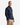 A man stands with one hand in his pocket, wearing the PROJEK RAW FLANNEL PLAID OVERSHIRT in blue and black, paired with relaxed fit khaki pants, looking seriously at the camera.