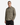 A person wearing the PROJEK RAW TWILL OVERSHIRT in light olive-green, featuring two chest pockets, stands facing forward with a neutral expression and one hand in their pocket, set against a plain white background—a perfect choice for transitional weather.