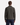 A person stands facing away against a plain white background, wearing the PROJEK RAW BUNGEE SOLID ZIPPER OVERSHIRT in dark olive and relaxed-fit navy pants.