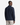A man stands with his back to the camera, wearing the PROJEK RAW BUNGEE SOLID OVERSHIRT in navy blue paired with light beige cargo pants. The outfit features a relaxed silhouette inspired by classic utility design, set against a plain white background.