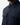 A close-up of a person wearing the PROJEK RAW BUNGEE SOLID OVERSHIRT, a dark navy utility-inspired shirt featuring large front pockets, a pointed collar, and a snap-button front, set against a plain light background.