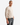 A person with short hair wears the PROJEK RAW CLASSIC FIT CHENILLE CREWNECK SWEATER and gray jeans, standing with one hand in their pocket against a plain white background.