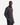 A man wearing a PROJEK RAW BONDED CHENILLE 1/4″ ZIP PULLOVER SWEATER in dark gray over a white shirt stands with his hands in his pants pockets, looking at the camera against a plain white background.