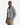 A man stands facing slightly to the side against a plain white background, layering the PROJEK RAW BONDED CHENILLE ZIP-UP HOODIE in light gray over a white tank top and beige cargo pants for a cozy, casual look.