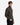 A young man with short brown hair wears the PROJEK RAW CLASSIC FIT JACQUARD KNIT PULLOVER 1/4″ ZIP SWEATER in dark green paired with black pants. He stands sideways with his right hand in his pocket, looking toward the camera against a plain white background.