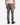 A person is shown from the back, standing against a plain white background, wearing a white tank top, black boots, a chain bracelet, and the PROJEK RAW BARU CLASSIC STRAIGHT FIT DENIM in a grey wash with straight-leg styling.