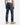 A man wearing PROJEK RAW’s BARU CLASSIC STRAIGHT FIT DENIM jeans in indigo, paired with a white sleeveless shirt and tan boots, stands facing away from the camera against a plain white background.