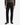 A person wearing PROJEK RAW’s BARU CLASSIC COLORED KNIT DENIM jeans, paired with a brown ribbed sweater and black dress shoes, stands against a plain white background.