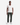 A man stands facing forward against a plain white background, wearing a white V-neck T-shirt, PROJEK RAW’s BARU CLASSIC COLORED KNIT DENIM straight leg jeans in a dark green wash, and white sneakers.