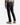 A person wearing a plaid shirt, tan boots, and the PROJEK RAW BARU CLASSIC STRAIGHT FIT DENIM in blue-black stands with their back to the camera against a plain white background, highlighting a classic everyday wear look.
