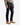 A person wearing a plaid shirt, PROJEK RAW’s BARU CLASSIC STRAIGHT FIT DENIM in blue-black, and beige suede boots stands against a plain white background, effortlessly showcasing an ideal look for everyday wear.